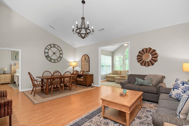 161 Patriot Ln, Pawleys Island, SC 29585 - living room with vaulted ceiling, a chandelier, and wood finished floors