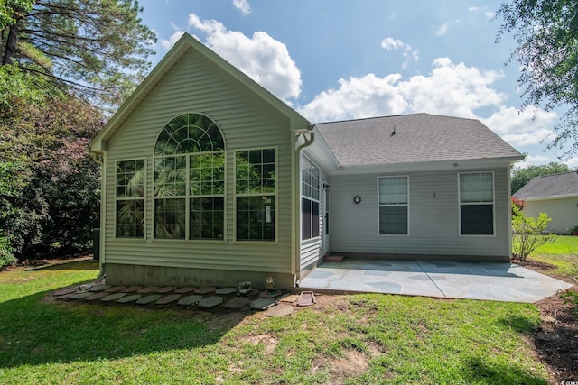161 Patriot Ln, Pawleys Island, SC 29585 - back of property featuring a patio area, a yard, and roof with shingles