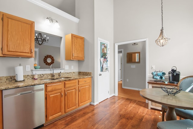 161 Patriot Ln, Pawleys Island, SC 29585 - kitchen with stainless steel dishwasher, a high ceiling, wood finished floors, a chandelier, and light stone countertops