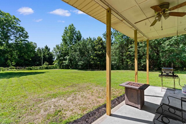 308 Old Stage Rd, Mullins, SC 29574 - view of green lawn with a ceiling fan, view of scattered trees, and a patio