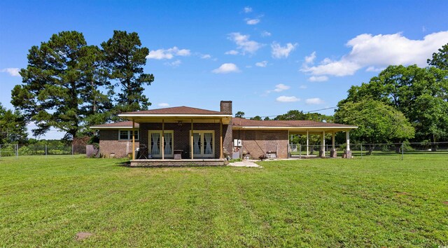 308 Old Stage Rd, Mullins, SC 29574 - rear view of house featuring french doors, a chimney, a patio area, and brick siding