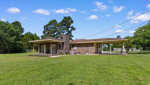 308 Old Stage Rd, Mullins, SC 29574 - rear view of house featuring a chimney, brick siding, and central AC unit