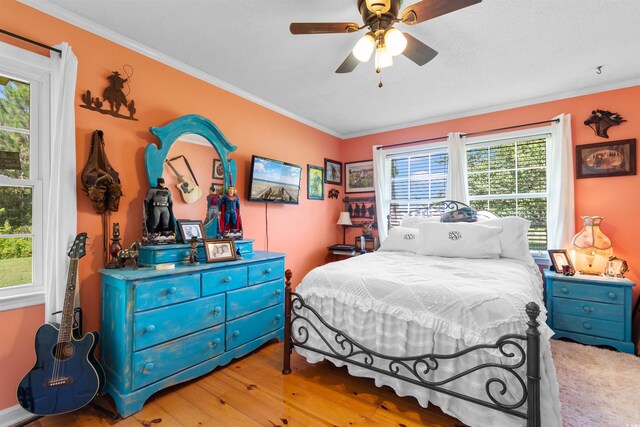 308 Old Stage Rd, Mullins, SC 29574 - bedroom with multiple windows, ornamental molding, wood finished floors, and ceiling fan