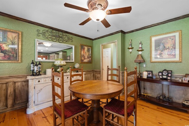 308 Old Stage Rd, Mullins, SC 29574 - dining room featuring light wood finished floors, ceiling fan, crown molding, a wainscoted wall, and a textured wall