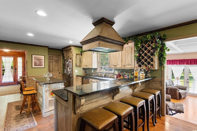 308 Old Stage Rd, Mullins, SC 29574 - kitchen featuring stainless steel appliances, a sink, crown molding, a kitchen island, and decorative backsplash