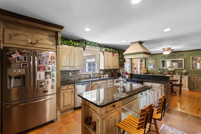 308 Old Stage Rd, Mullins, SC 29574 - kitchen with stainless steel appliances, a sink, a center island, decorative backsplash, and tile patterned flooring