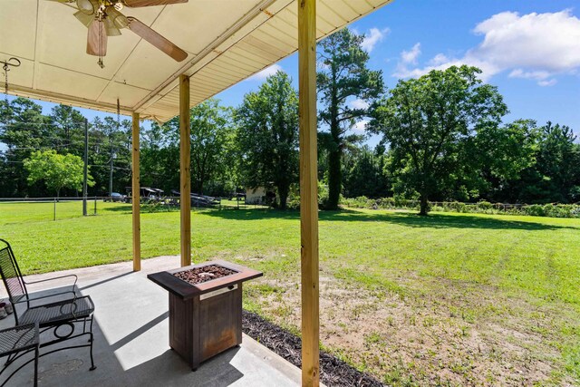 308 Old Stage Rd, Mullins, SC 29574 - view of patio / terrace with a ceiling fan, view of wooded area, and an outdoor fire pit