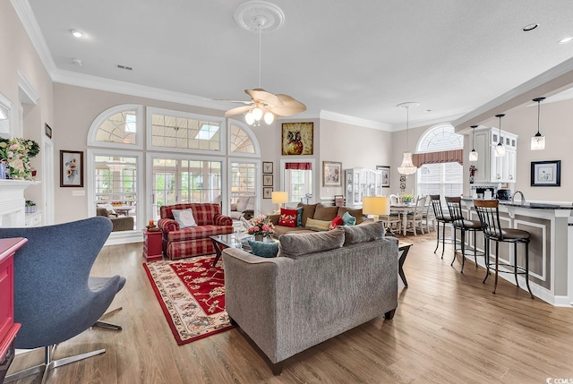 6434 Longwood Dr, Murrells Inlet, SC 29576 - living room with ornamental molding, plenty of natural light, wood finished floors, a ceiling fan, and recessed lighting
