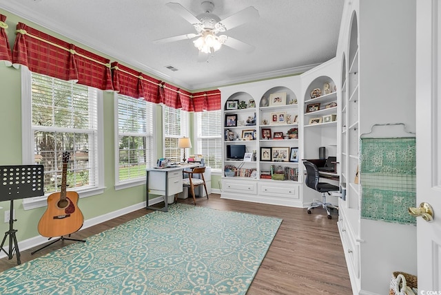 6434 Longwood Dr, Murrells Inlet, SC 29576 - home office featuring ceiling fan, wood finished floors, crown molding, baseboards, and built in study area
