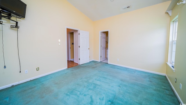 434 Deer Path, Calabash, NC 28467 - unfurnished bedroom featuring carpet floors, lofted ceiling, multiple windows, and baseboards