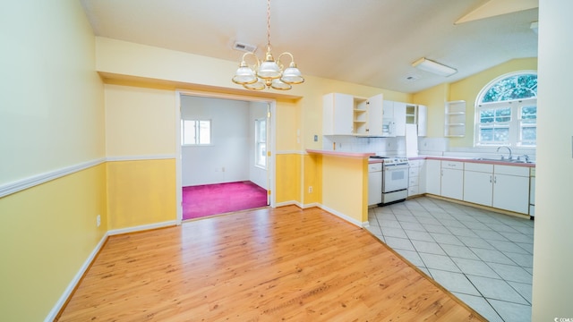 434 Deer Path, Calabash, NC 28467 - kitchen with white electric range oven, open shelves, white cabinetry, a chandelier, and a sink