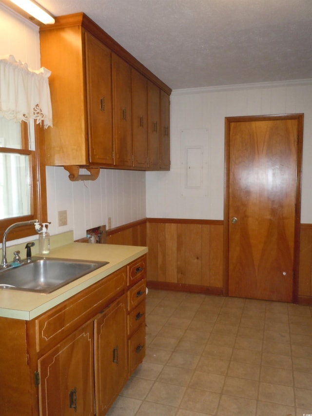 8202 Joe Brown Hwy S, Clarendon, NC 28432 - kitchen featuring brown cabinetry, light countertops, crown molding, wooden walls, and electric panel