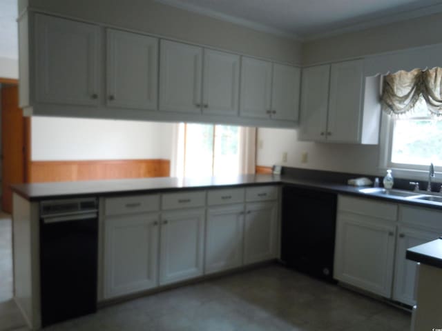 8202 Joe Brown Hwy S, Clarendon, NC 28432 - kitchen with a sink, dishwasher, crown molding, a peninsula, and white cabinetry