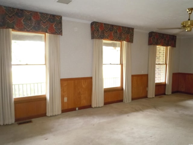 8202 Joe Brown Hwy S, Clarendon, NC 28432 - unfurnished room featuring crown molding, wooden walls, wainscoting, carpet, and ceiling fan