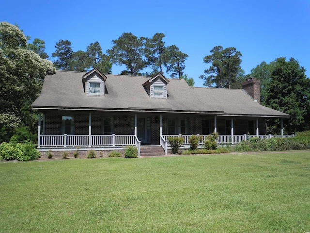 8202 Joe Brown Hwy S, Clarendon, NC 28432 - view of front facade featuring covered porch, a front yard, brick siding, and a chimney