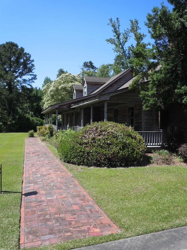 8202 Joe Brown Hwy S, Clarendon, NC 28432 - view of side of home featuring a yard and covered porch