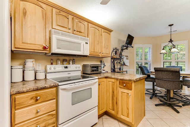 24 Gate 7, Carolina Shores, NC 28467 - kitchen featuring white appliances, a peninsula, decorative light fixtures, light tile patterned flooring, and a textured ceiling