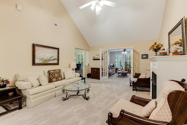 24 Gate 7, Carolina Shores, NC 28467 - living area with high vaulted ceiling, ceiling fan, light carpet, french doors, and a fireplace with flush hearth