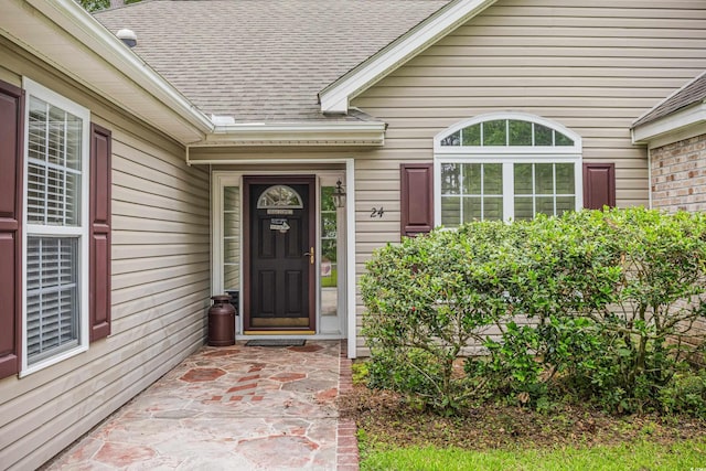 24 Gate 7, Carolina Shores, NC 28467 - doorway to property featuring a shingled roof
