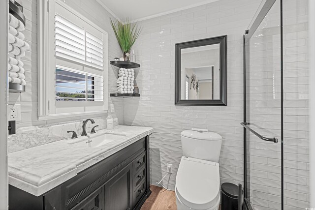 4534 Landing Rd, Little River, SC 29566 - bathroom featuring crown molding, vanity, toilet, wood finished floors, and tile walls