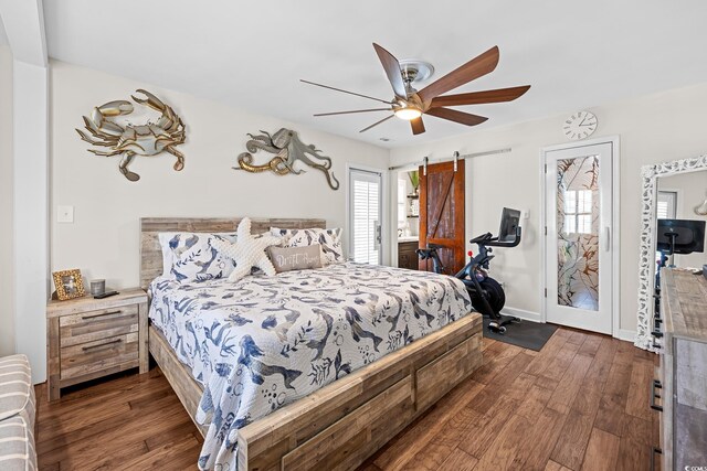 4534 Landing Rd, Little River, SC 29566 - bedroom featuring dark wood finished floors, multiple windows, a barn door, and a ceiling fan