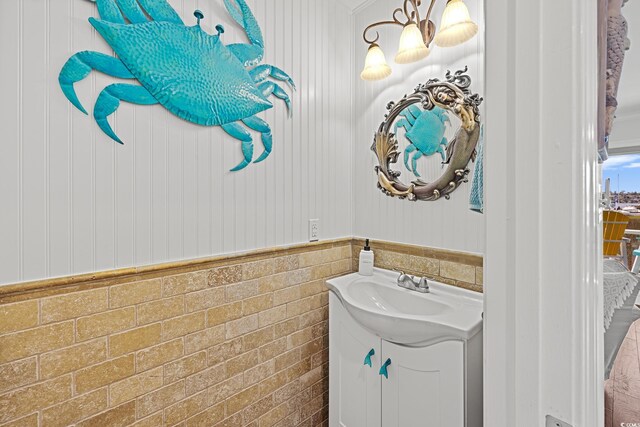 4534 Landing Rd, Little River, SC 29566 - bathroom with vanity, a chandelier, tile walls, and wainscoting