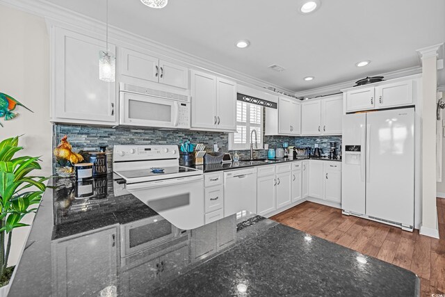 4534 Landing Rd, Little River, SC 29566 - kitchen with white appliances, a sink, wood finished floors, white cabinets, and recessed lighting