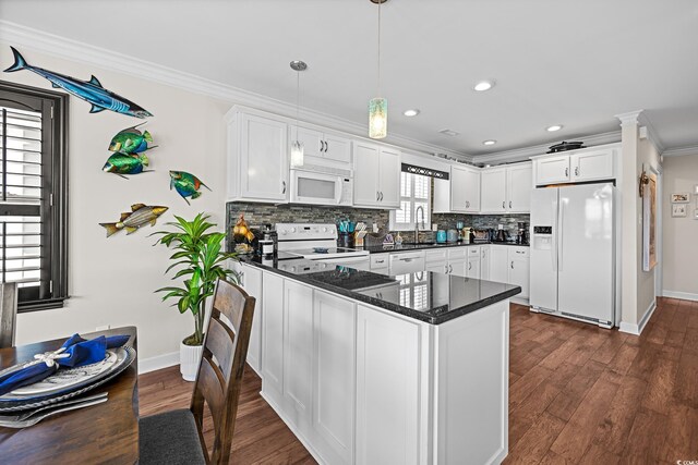 4534 Landing Rd, Little River, SC 29566 - kitchen featuring white appliances, crown molding, a peninsula, white cabinets, and backsplash