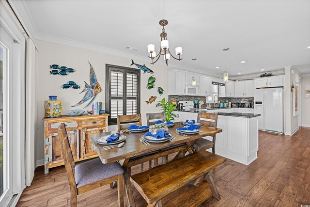 4534 Landing Rd, Little River, SC 29566 - dining space with crown molding, plenty of natural light, a chandelier, wood finished floors, and recessed lighting