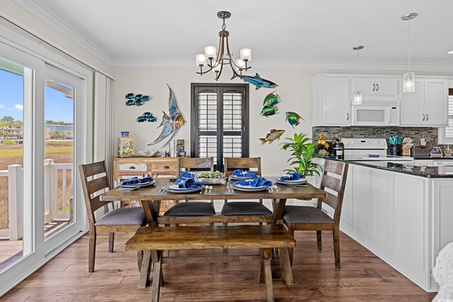 4534 Landing Rd, Little River, SC 29566 - dining area with a chandelier, light wood-style flooring, and crown molding