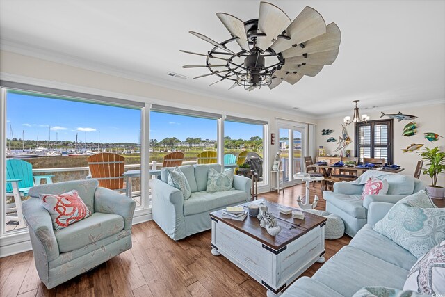 4534 Landing Rd, Little River, SC 29566 - living room with a chandelier, ceiling fan, hardwood / wood-style floors, and ornamental molding