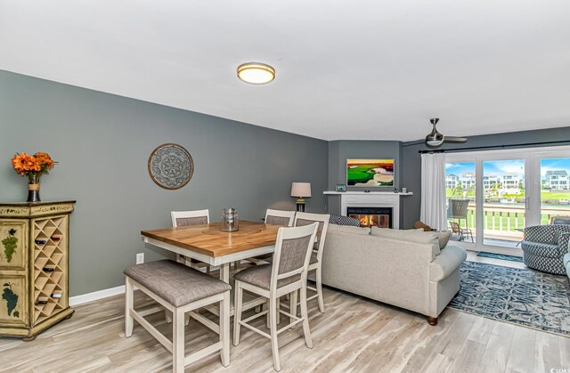 4018 Fairway Lakes Dr Unit 4018, Myrtle Beach, SC 29577 - dining room with light wood-style flooring, a glass covered fireplace, and a ceiling fan