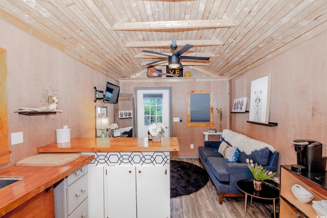 514 Blockade Dr, Pawleys Island, SC 29585 - kitchen with butcher block countertops, wood ceiling, wood finished floors, a ceiling fan, and a peninsula