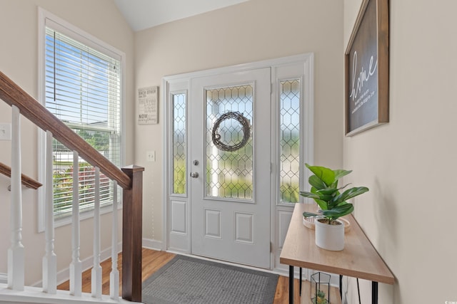309 Foxpath Loop, Myrtle Beach, SC 29588 - foyer entrance featuring stairs, plenty of natural light, wood finished floors, and vaulted ceiling