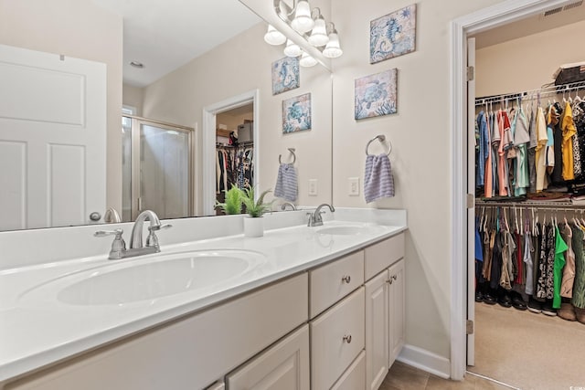 309 Foxpath Loop, Myrtle Beach, SC 29588 - full bath with double vanity, a walk in closet, a shower stall, and tile patterned floors