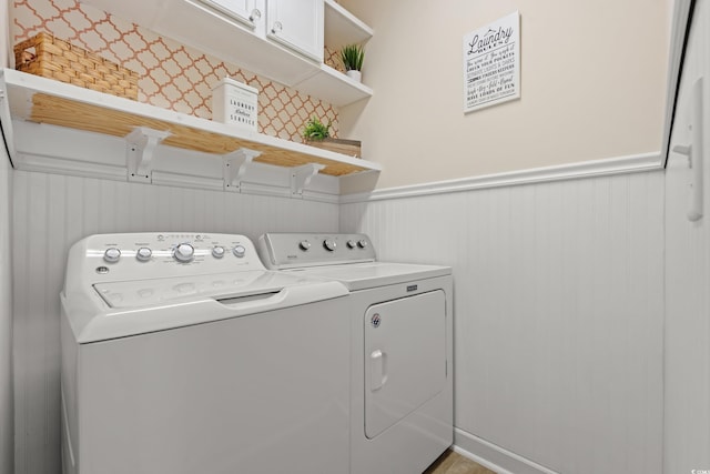 309 Foxpath Loop, Myrtle Beach, SC 29588 - laundry area with washer and dryer, cabinet space, and a wainscoted wall