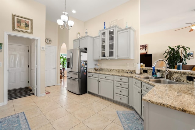 357 Southern Breezes Cir, Murrells Inlet, SC 29576 - kitchen with stainless steel fridge, arched walkways, a ceiling fan, glass insert cabinets, and a peninsula