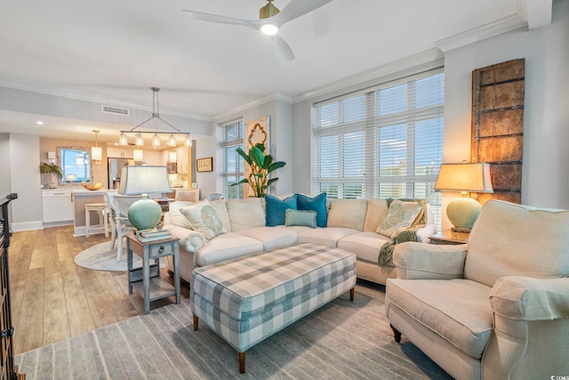 603 S Ocean Blvd Unit 1504, North Myrtle Beach, SC 29582 - living room with a ceiling fan, light wood-style flooring, ornamental molding, and plenty of natural light