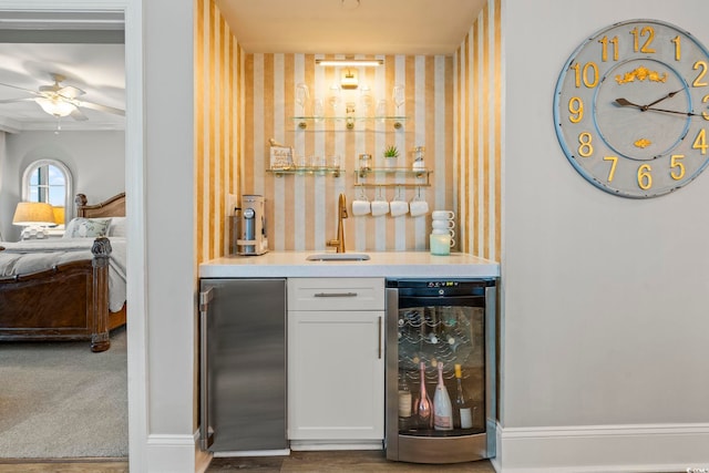 603 S Ocean Blvd Unit 1504, North Myrtle Beach, SC 29582 - indoor wet bar featuring beverage cooler, wallpapered walls, and a ceiling fan