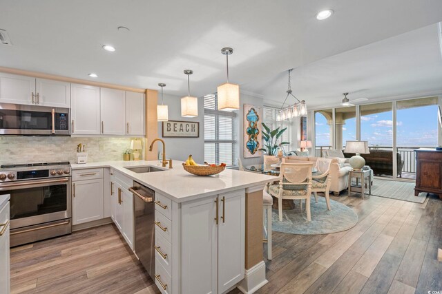 603 S Ocean Blvd Unit 1504, North Myrtle Beach, SC 29582 - kitchen with appliances with stainless steel finishes, a peninsula, backsplash, healthy amount of natural light, and recessed lighting