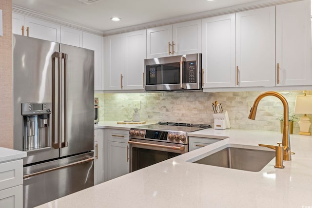 603 S Ocean Blvd Unit 1504, North Myrtle Beach, SC 29582 - kitchen with stainless steel appliances, white cabinets, tasteful backsplash, light stone counters, and recessed lighting