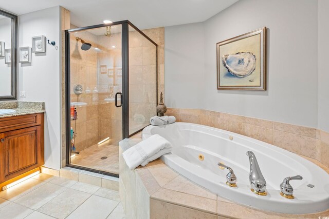 603 S Ocean Blvd Unit 1504, North Myrtle Beach, SC 29582 - bathroom with a whirlpool tub, vanity, a stall shower, and tile patterned flooring