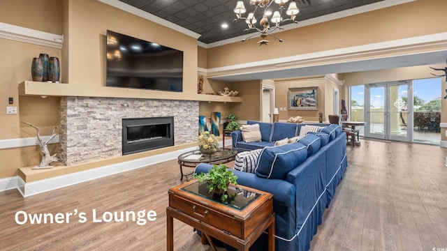 603 S Ocean Blvd Unit 1504, North Myrtle Beach, SC 29582 - living room with a chandelier, an ornate ceiling, crown molding, wood finished floors, and a fireplace