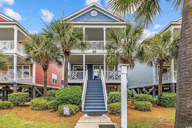 22 Ocean Blvd N, Surfside Beach, SC 29575 - view of front of home featuring stairway, a balcony, and a porch