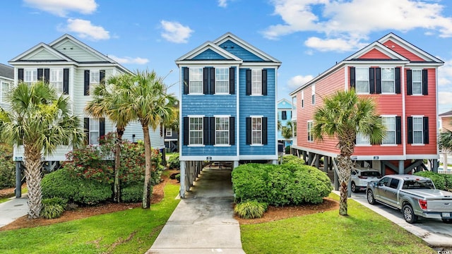 22 Ocean Blvd N, Surfside Beach, SC 29575 - coastal home featuring a carport, driveway, and a front lawn