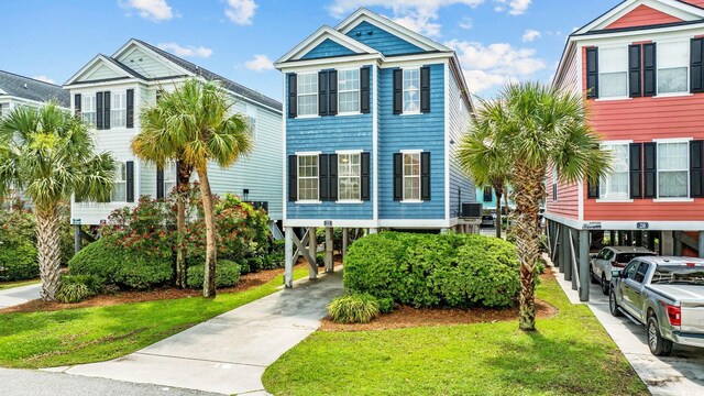 22 Ocean Blvd N, Surfside Beach, SC 29575 - beach home with a carport, driveway, and a front yard