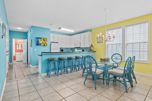22 Ocean Blvd N, Surfside Beach, SC 29575 - dining room with a chandelier and light tile patterned flooring