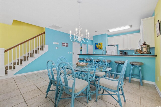 22 Ocean Blvd N, Surfside Beach, SC 29575 - dining area featuring a chandelier, light tile patterned floors, and stairway