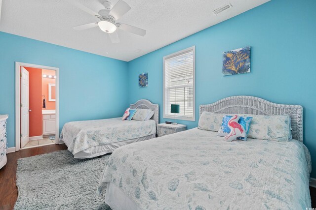 22 Ocean Blvd N, Surfside Beach, SC 29575 - bedroom with wood finished floors, a ceiling fan, ensuite bathroom, and a textured ceiling