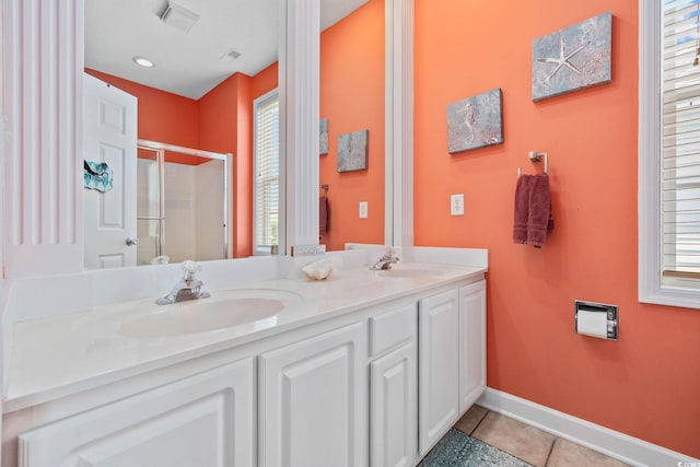 22 Ocean Blvd N, Surfside Beach, SC 29575 - bathroom featuring a stall shower, double vanity, tile patterned floors, and plenty of natural light
